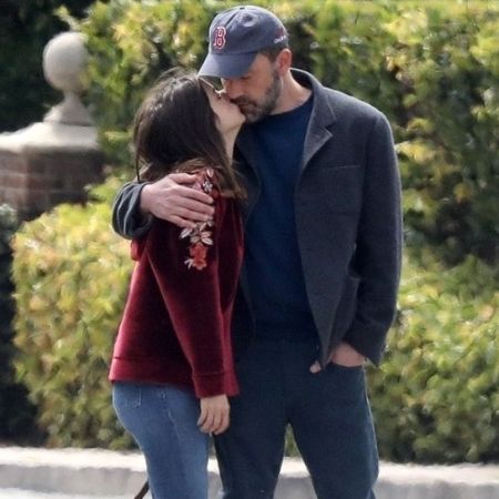 Affleck kissing Ana while walking their dogs 
